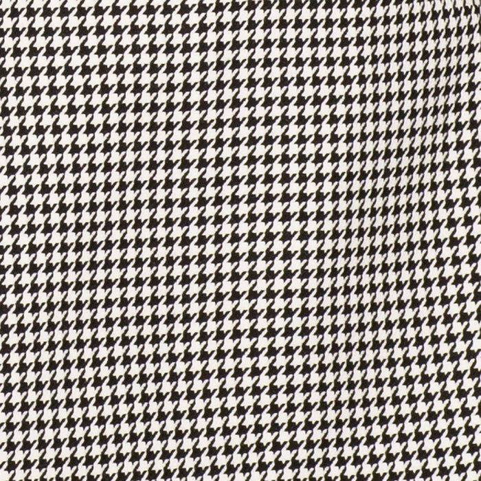Close-up detail of black houndstooth suit jacket fabric pattern